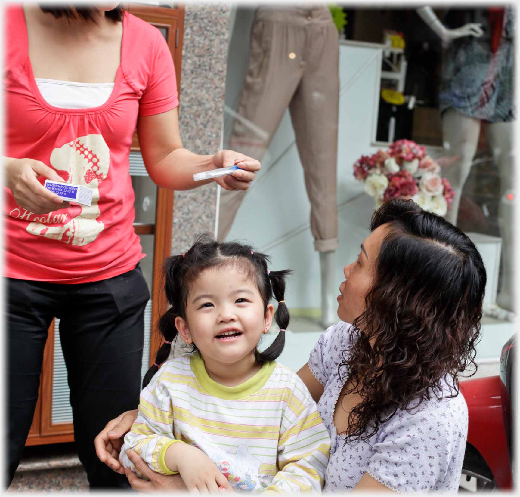 Infant smiling in direction of camera.