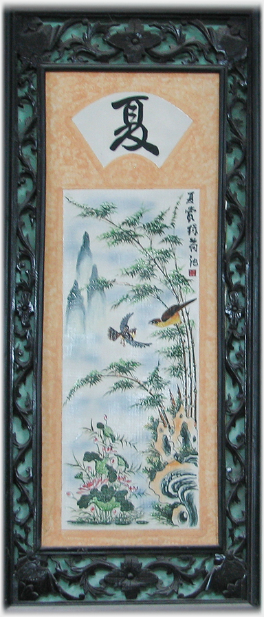 Vertical panel in ornate frame with birds, hills and bamboo.
