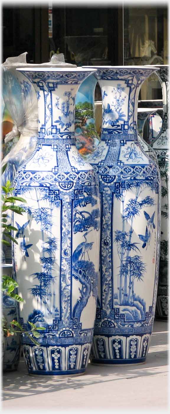 Two large vases at entrance to one of the shops.