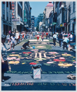 Street carpeted with flower pictures.