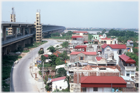 Double decker bridge at left houses in front.