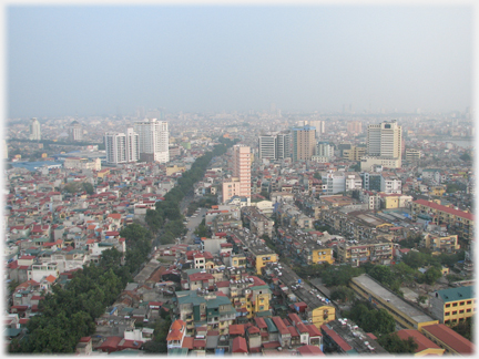 View across city with mostly low rise buildings and some blocks.