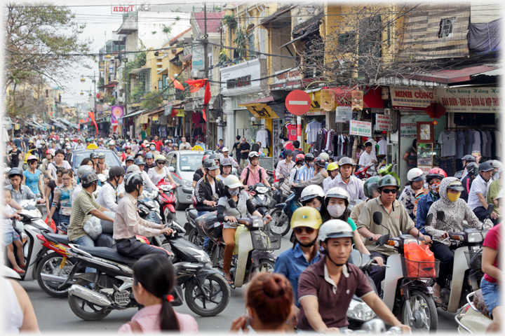 Shopping street solid with motorbikes as far as can be seen.