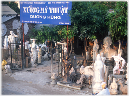 Workshop grounds with many statues in while material.