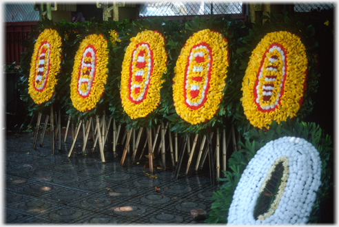 Large oval floral wreaths on stands.