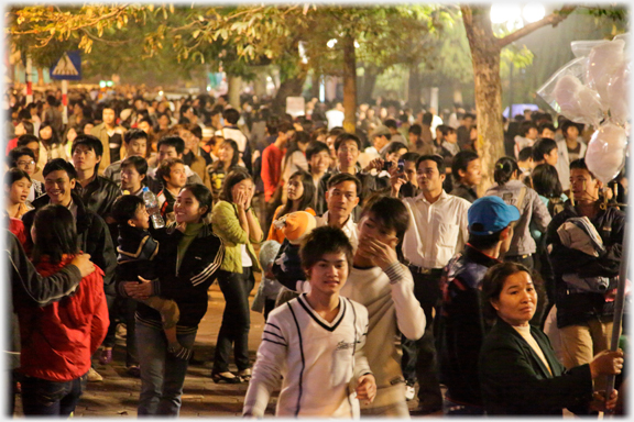 Very large crowd filling street into the far distance.