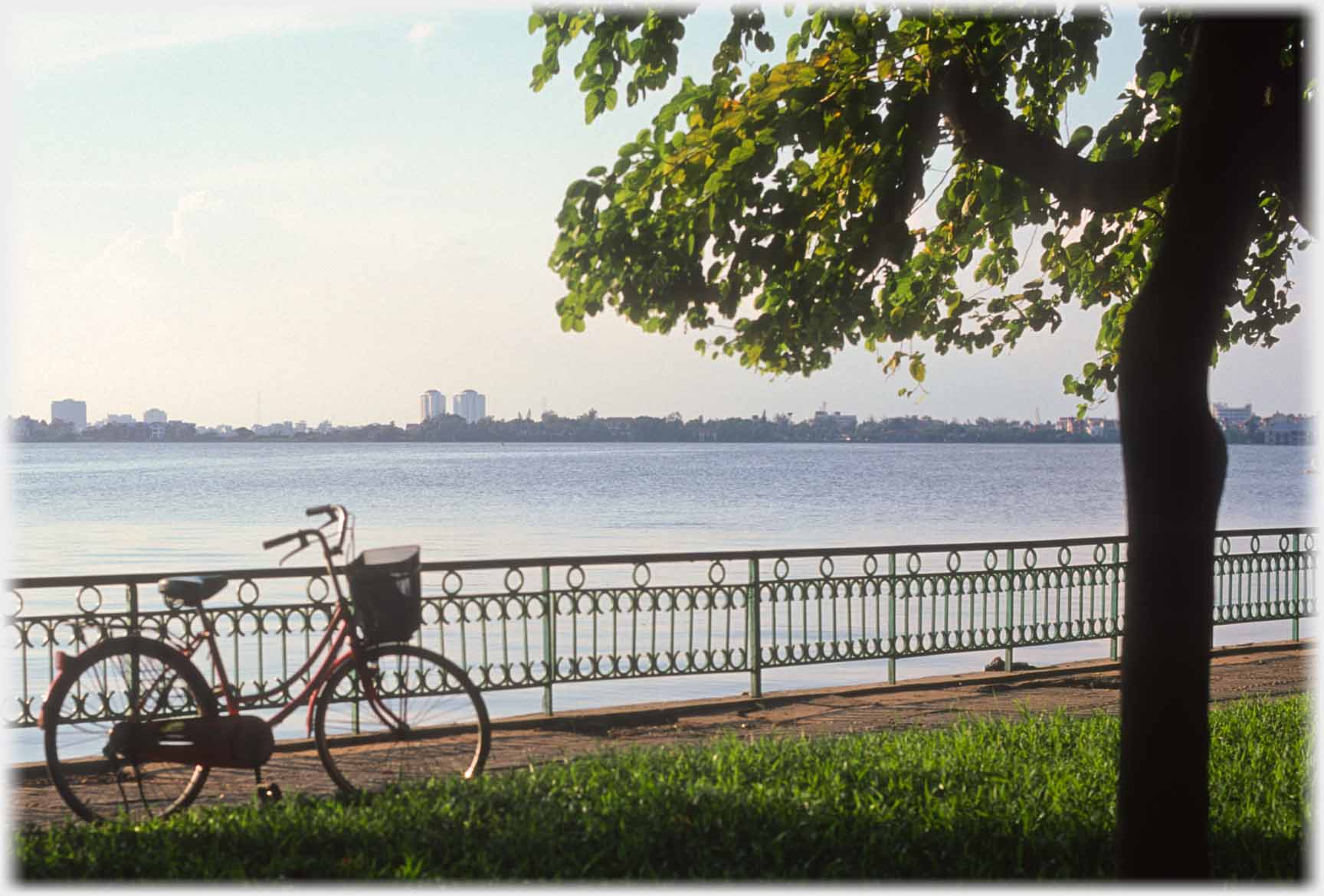 Bicycle standing with view of the lake.