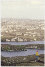 Looking across rock and heather, person bottom corner.