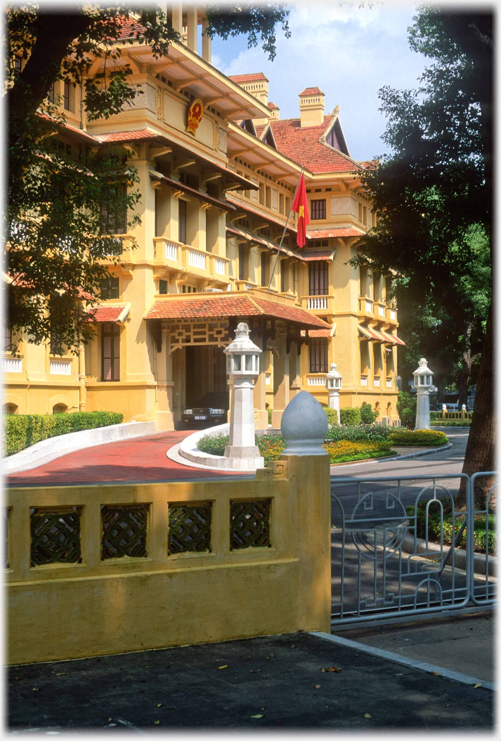 Facade of large building with gates in foreground.