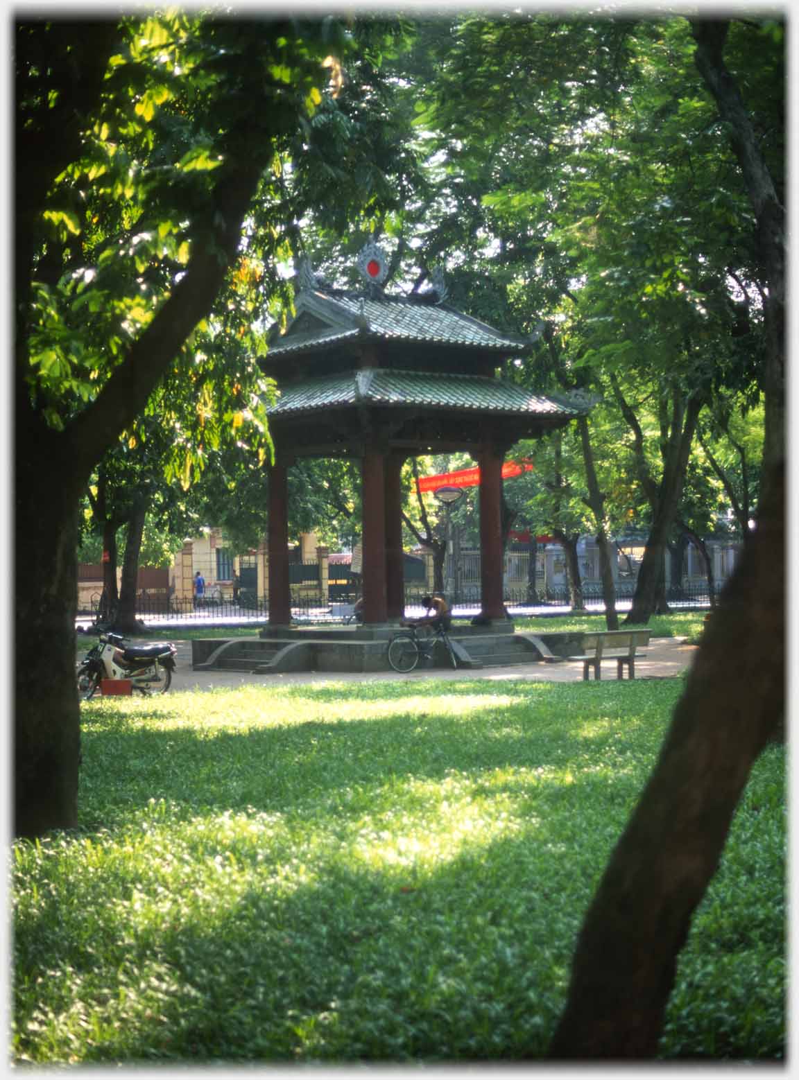 Small four pillard pavillion amongst trees.