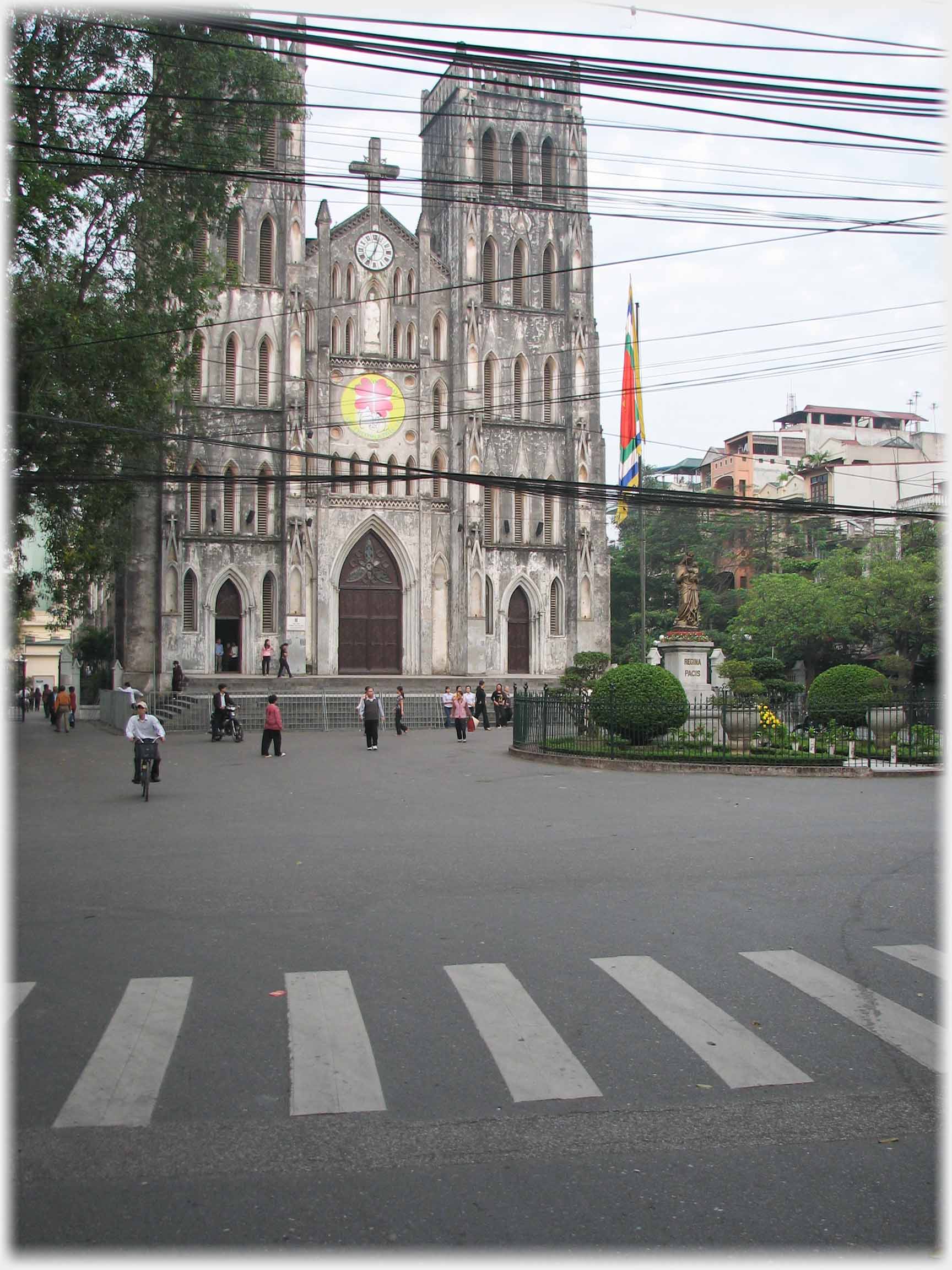 Street with church and large numbes of cable crossing view.