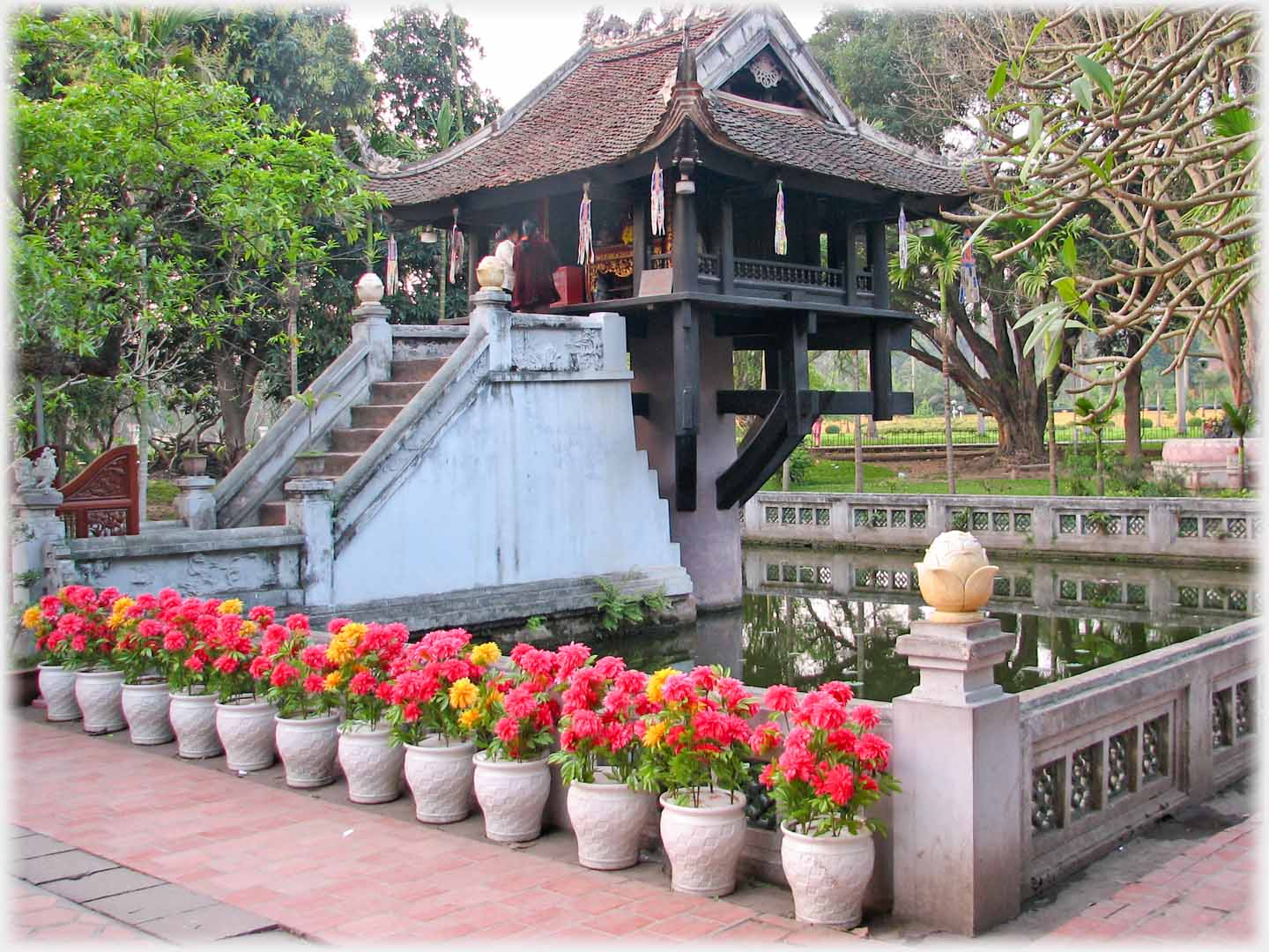 Flowers in front of balustrade round pool in which is the pagoda on column.