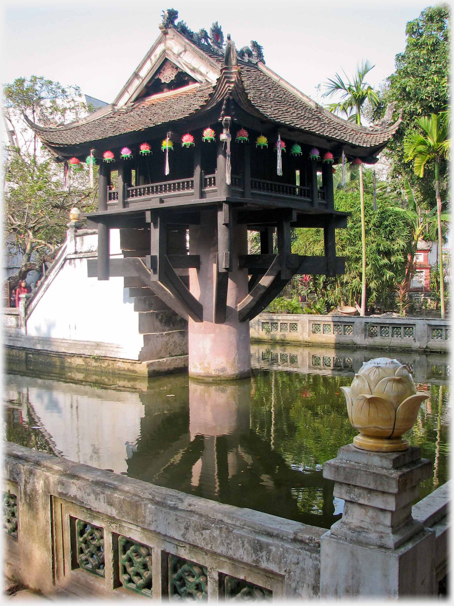 Small pagoda on column in pool.