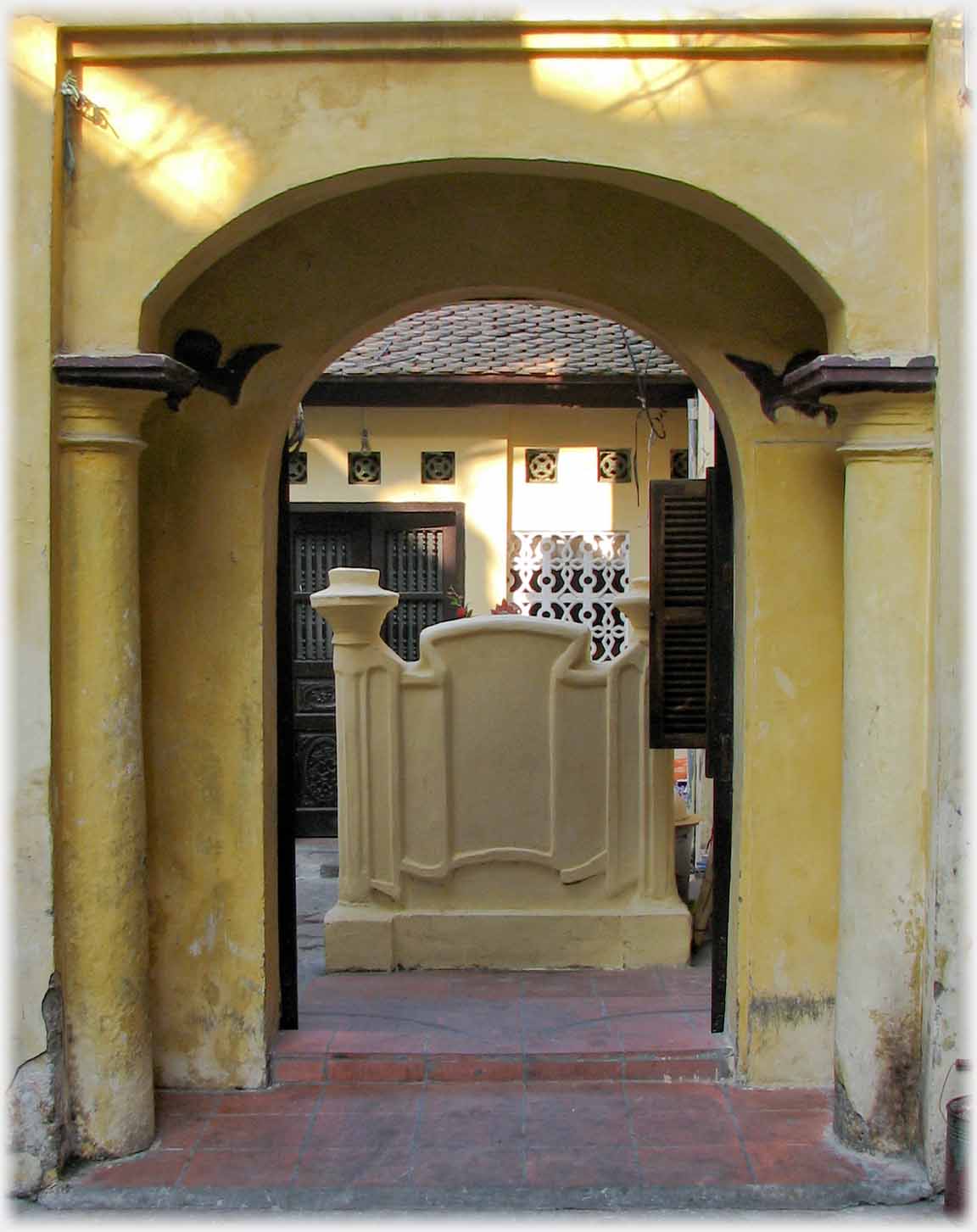 Looking through pagoda entrance at screen.