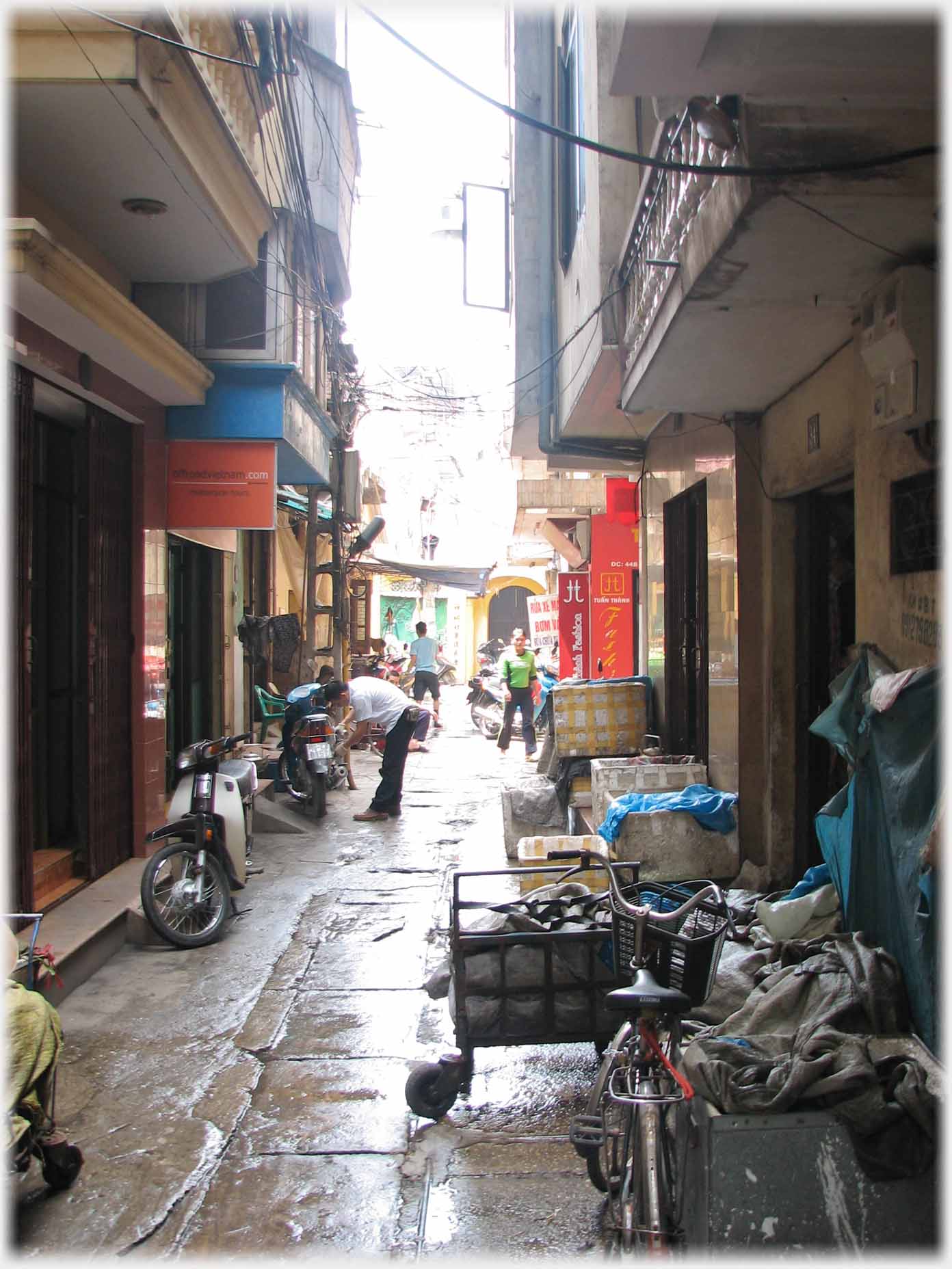 Looking along lane with barrow and bikes.