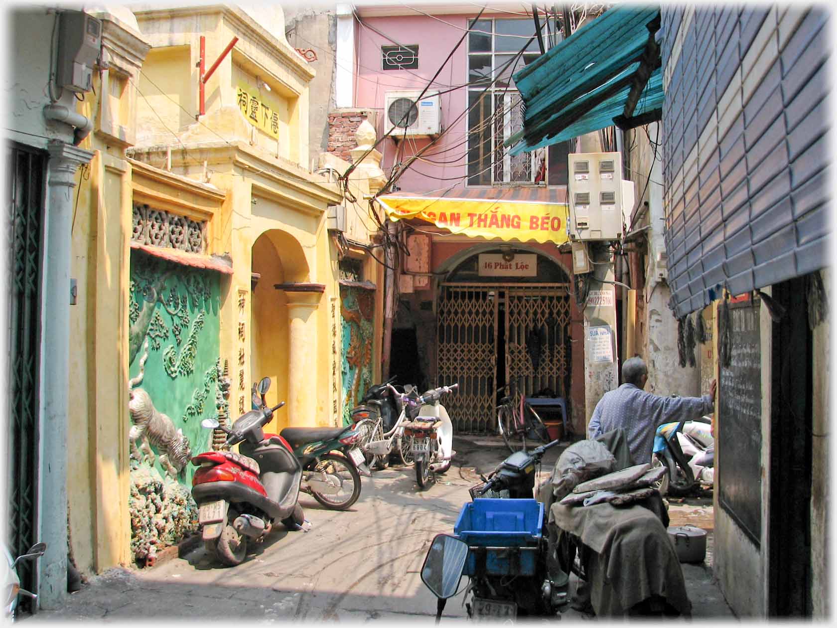 Corner of lane with decorative entrance and panels.