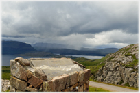 Indicator board with mountains and sea beyond.