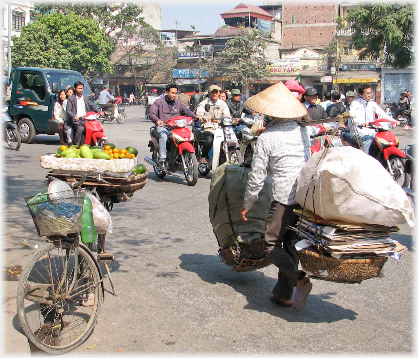 Panniers with large sacks on top of piles of cardboard.