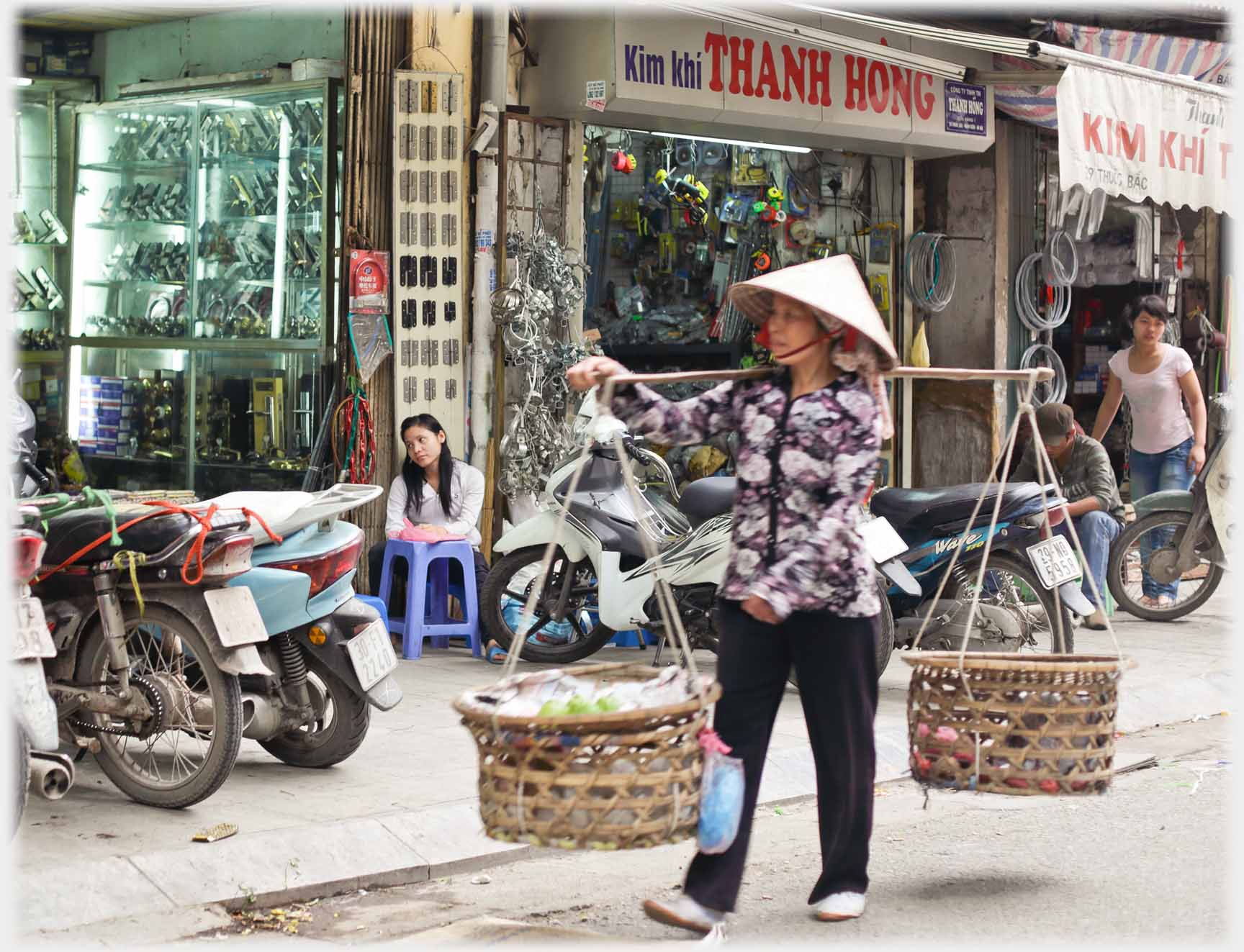 Woman with pannier baskets of wide open weave.