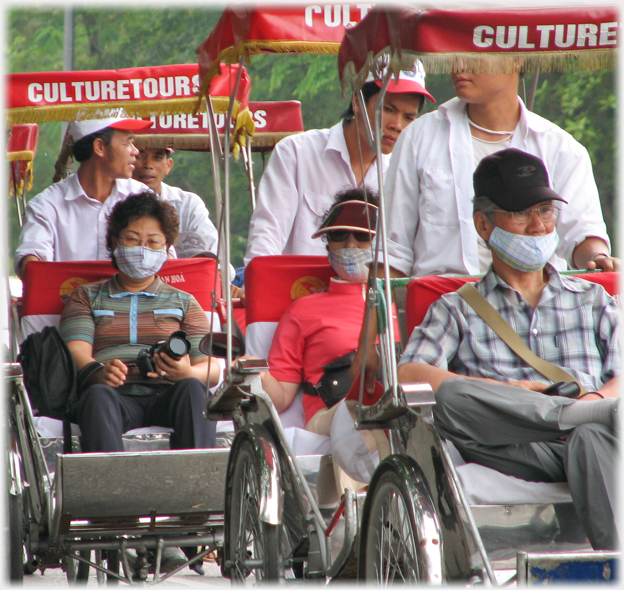 Three rickshaw occupants.