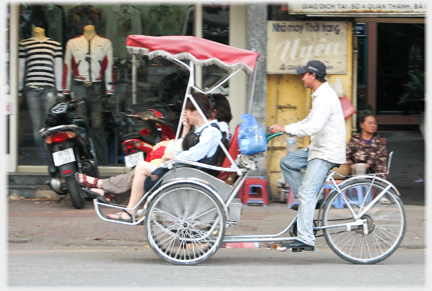 Side view of passing rickshaw.