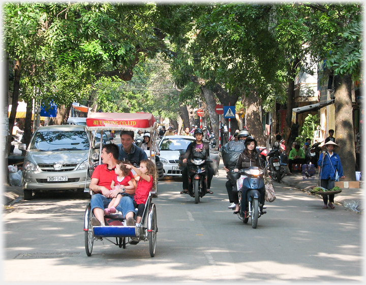 Man looking, child pointing in rickshaw