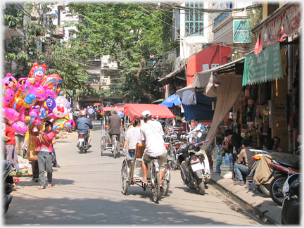 Street scene with rickshaw going away.