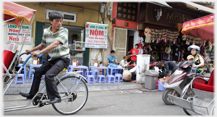 Man riding rickshaw turning towards another one.