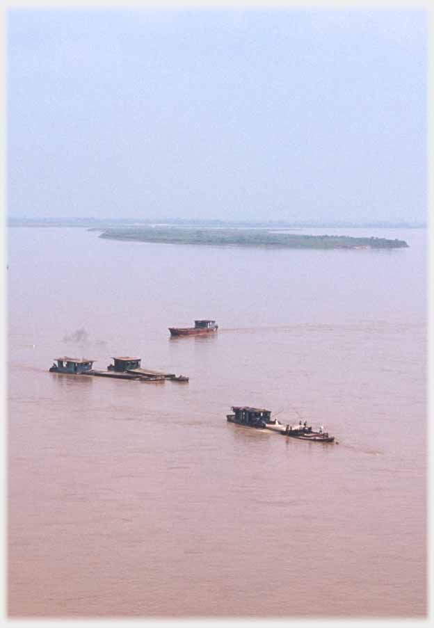 Four barges out on river.