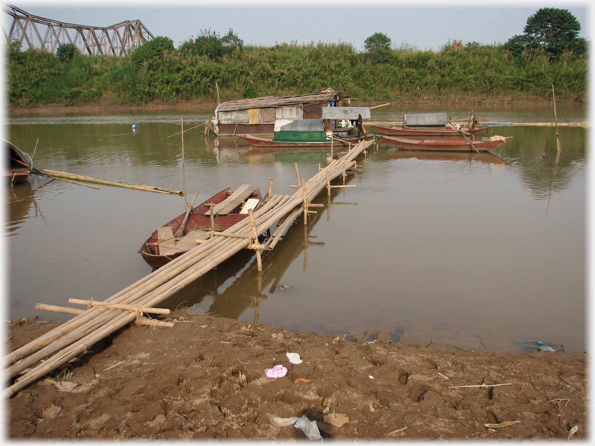 Five bamboo wide bridge running out to houseboat.