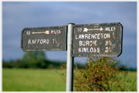 Old signpost with distances to near fraction.