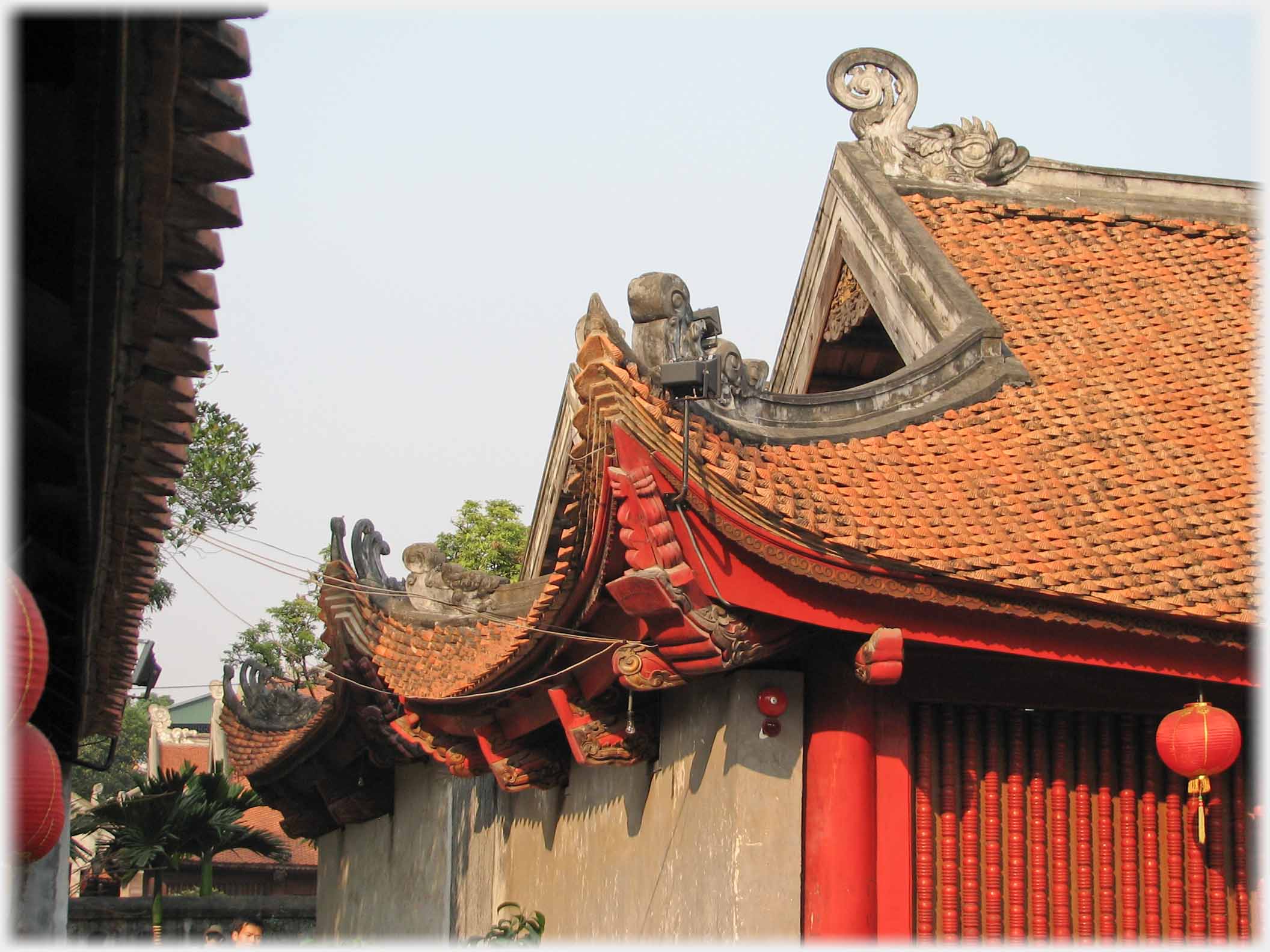 Along edge of roof with upturned eaves and supports.