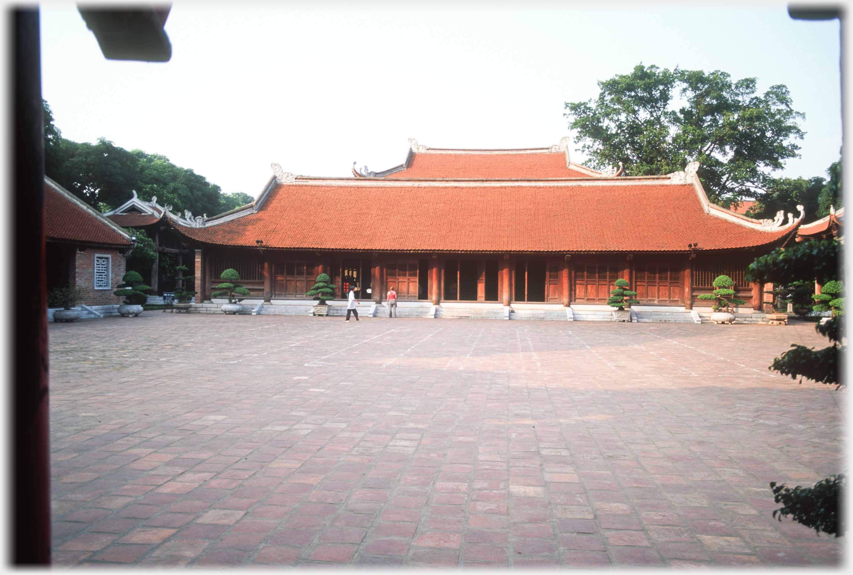 Courtyard with long building opposite.