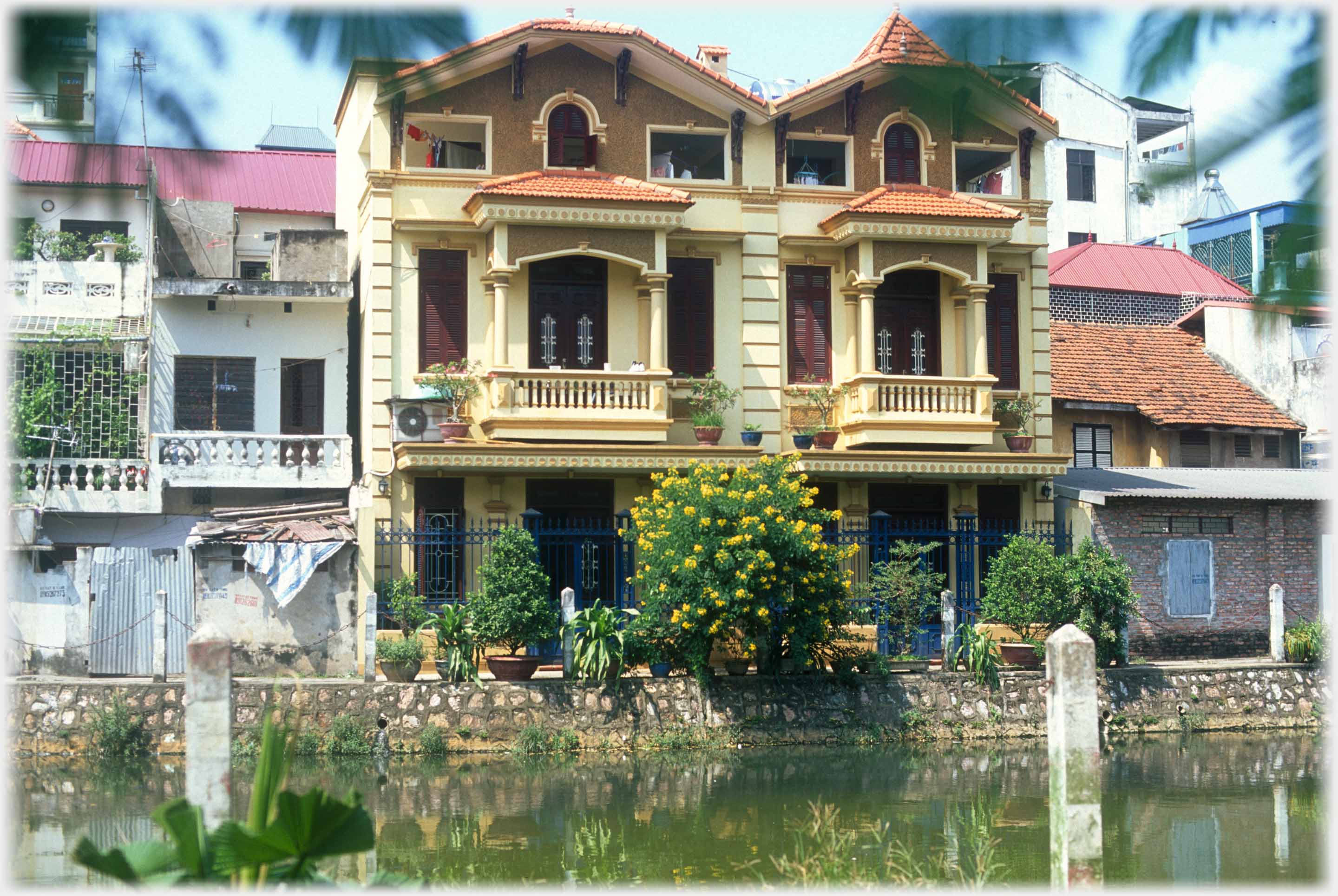 Two three story high quality houses with balconies.