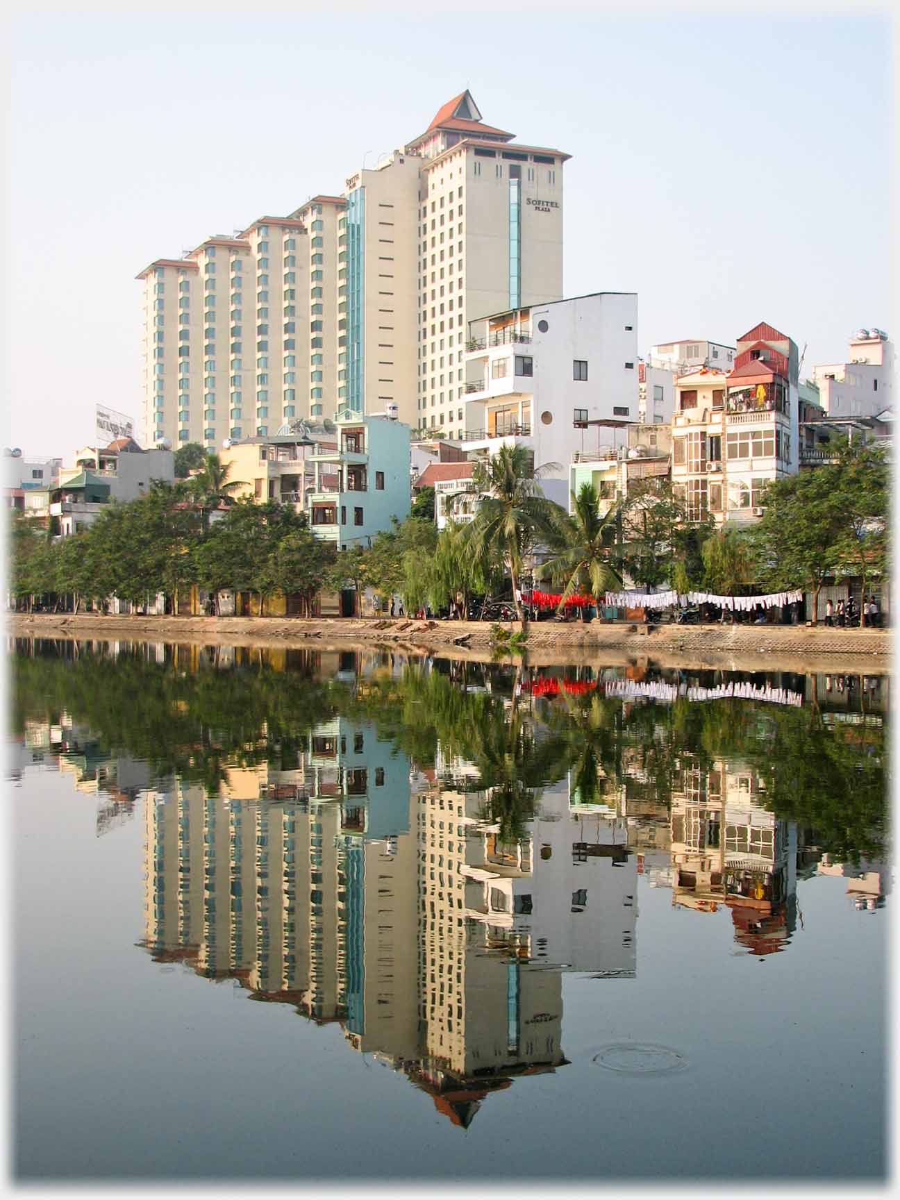 Multi-story tiered building reflected in lake