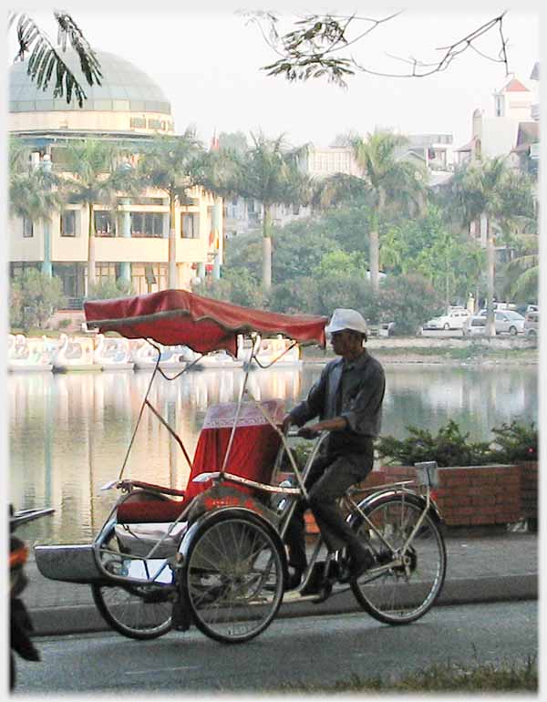 Cycle rickshaw by lake.