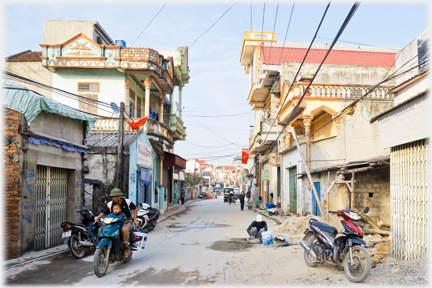 Main street and motorcyclist with child.