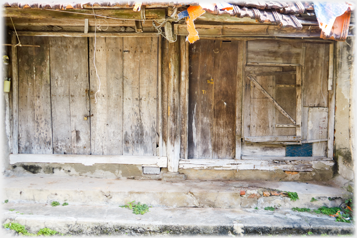 Two sets of doors in a state of complex poor repair.