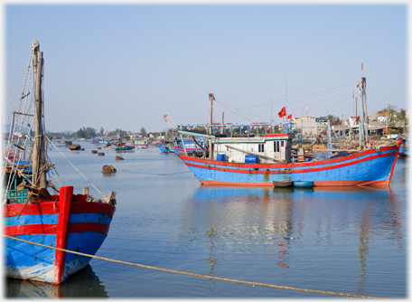 Fishing boat with boats dotting lagoon beyond.