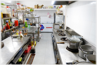 View of kitchen, cookers to the right.