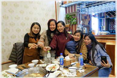 Five women toasting.