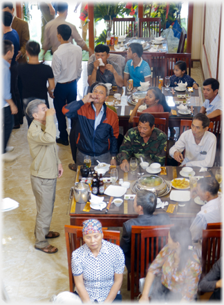 Tables with men toasting.