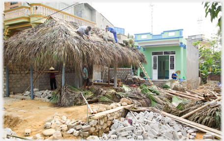 The roof of the cafe being thatched and an area of chaos beside it.