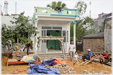 Front of the house just before completion with painters and workmen.