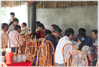 The covered part of the cafe with opening party guests.