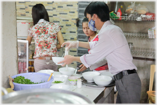 Bowls being filled with the noodles for pho.