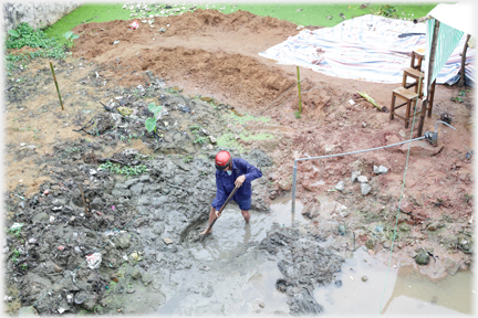 Man digging in the mud.