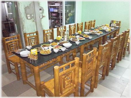 A meal laid out waiting diners, wall behind with scars of demolition.