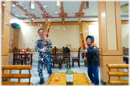 Two confetti tubes being released.