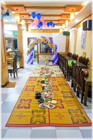 Mats laid out on the floor for a meal - charis and tables pushed to one side.